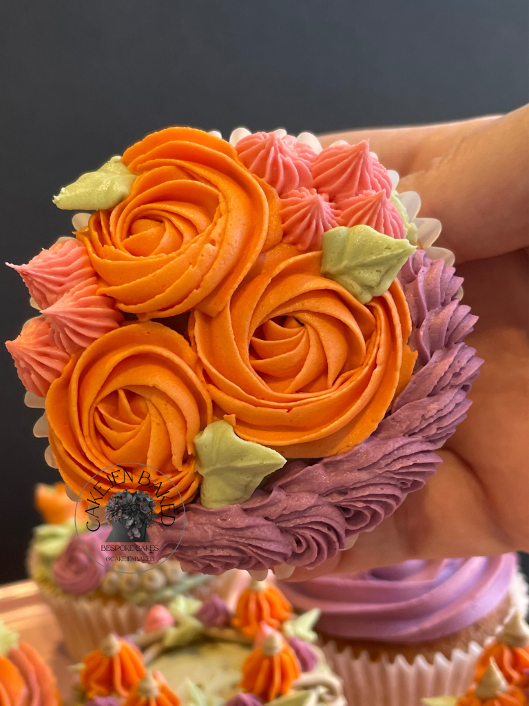 Autumnal or Halloween cupcakes. buttercream rose swirls 