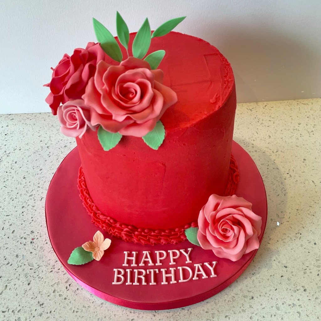 Buttercream birthday cake decorated with handmade sugar roses